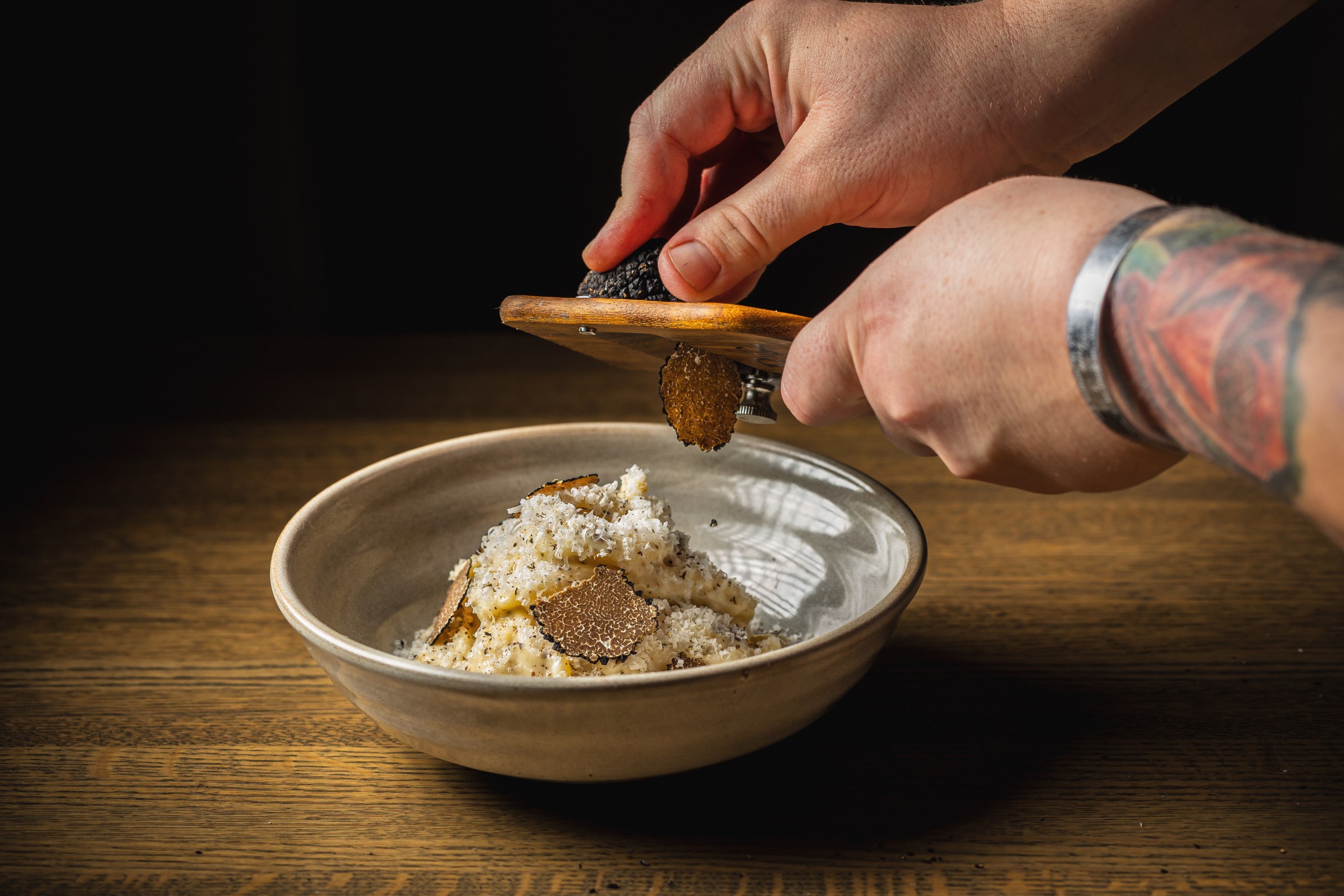 Truffle being shaved over a dish.