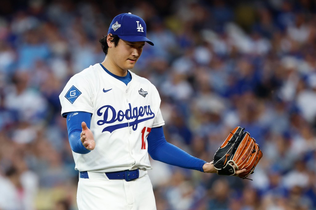 Shohei Ohtani #17 of the Los Angeles Dodgers reacts while walking to the dugout after giving up a two-run home run to Vladimir Guerrero Jr. #27 of the Toronto Blue Jays (not pictured) during the third inning in game four of the 2025 World Series at Dodger Stadium on October 28, 2025 in Los Angeles, California.