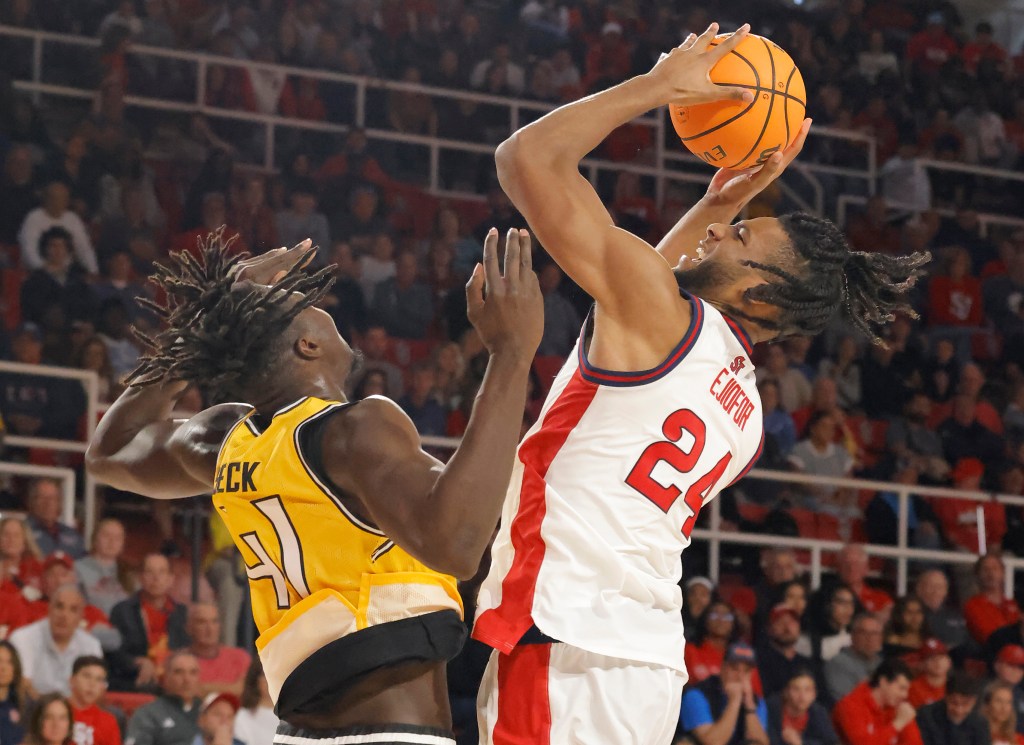 Zuby Ejiofor #24 of St. John's Red Storm goes up for a shot as Mor Seck #41 of the Towson Tigers defends.