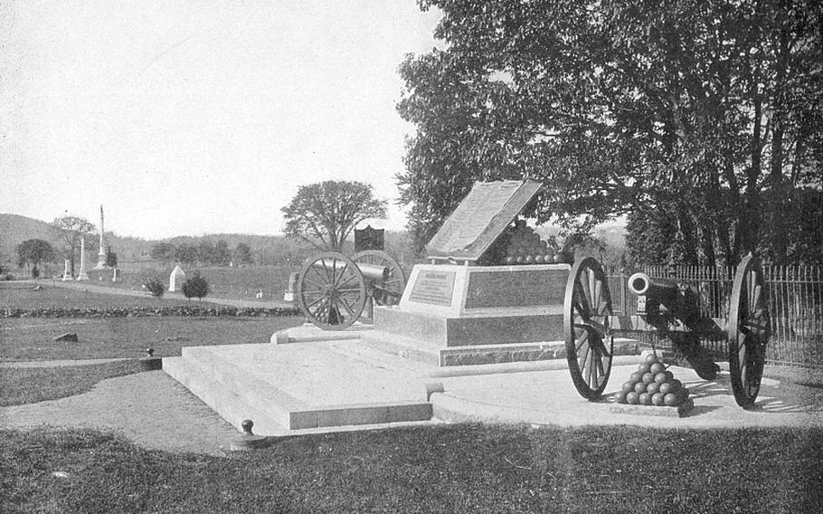 An old black and white photograph shows a Civil War monument that includes a cannon on wheels.