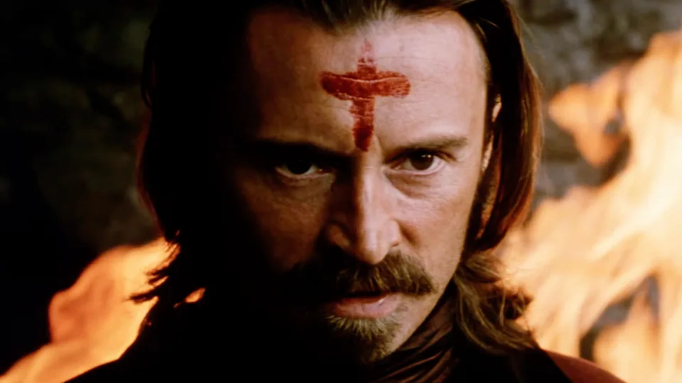 Robert Carlyle with a goatee and blood cross on forehead, staring in The Ravenous 1999. 