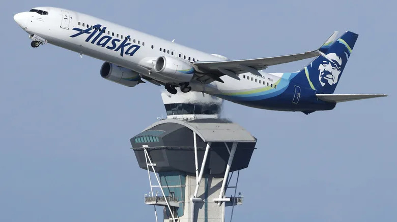 n Alaska Airlines plane takes off near the air traffic control tower at Los Angeles International Airport on October 22, 2025 in Los Angeles, California.