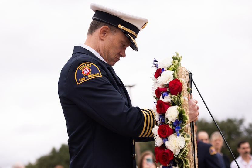 Dallas Fire-Rescue Chief Justin Ball prepares to lay the wreath in front of the Dallas...