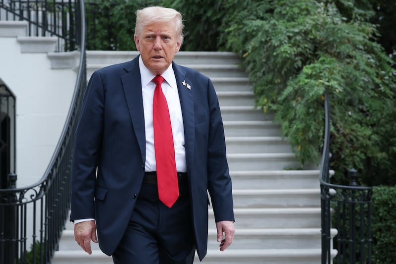 President Donald Trump walks toward members of the media before answering questions while departing the White House on September 30, 2025 in Washington, DC.