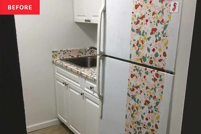 Small kitchen with white cabinets, a stainless steel sink, and a colorful terrazzo countertop and refrigerator wrap.