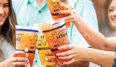 A promotional photo of people clinking their teas.