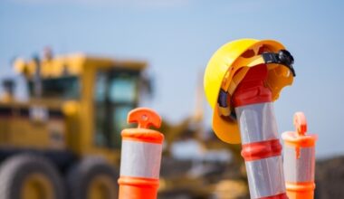 traffic barriers with a yellow hard hat hanging on it