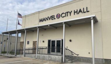building with sign that reads manvel city hall