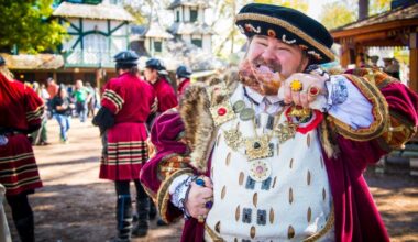 Renaissance faire performers with a king eating a turkey leg