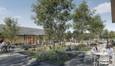 a rendering of an outdoor plaza with trees and table and chairs