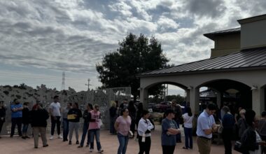 people stand in line outside to vote
