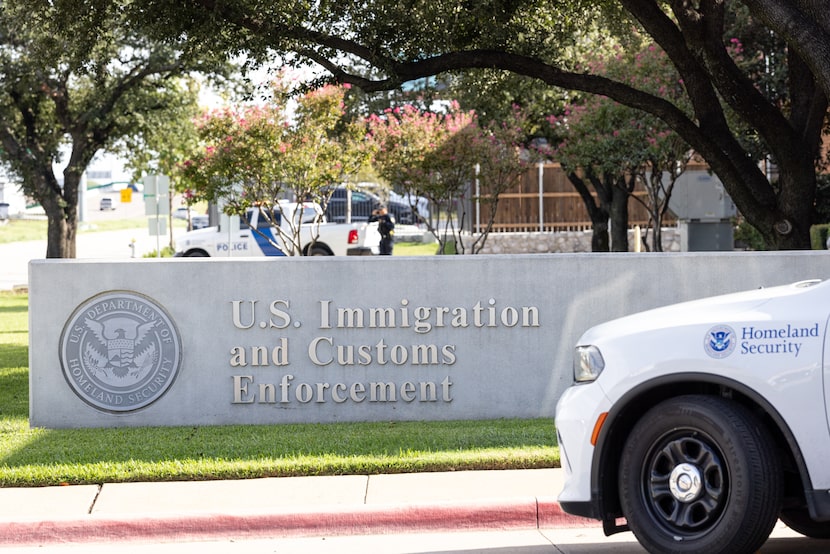 A sign outside of the main entrance to the Dallas Immigration and Customs Enforcement office...