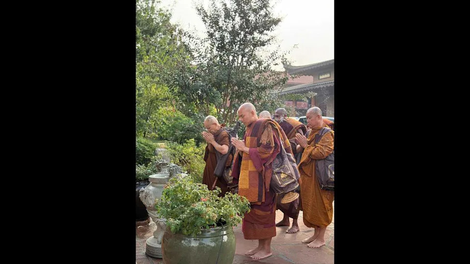 Bhikkhu Pannakara and fellow monks pray before beginning their walk for peace.