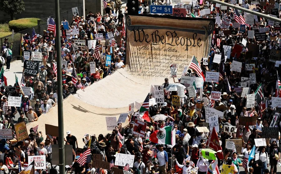 LOS ANGELES, CALIFORNIA – JUNE 14: Protesters carry a banner representing the Preamble to the U.S. Constitution in downtown Los Angeles during an anti-Trump “No Kings Day” demonstration on June 14, 2025 in Los Angeles, California. Hundreds of marches and protests against the Trump administration and its policies are happening across the United States today. Protesters are also reacting in opposition to a planned military parade celebrating the 250th anniversary of the U.S. Army that is taking place in Washington, DC and which coincides with President Trump’s birthday. (Photo by Mario Tama/Getty Images)