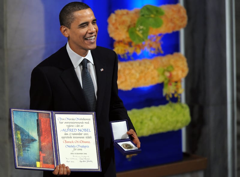 Former President Barack Obama, then 48, smiles with his diploma and gold medal during the 2009 Nobel Peace Prize ceremony.