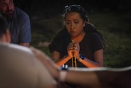 Janet Martínez leads a rosary prayer circle during a vigil outside of Parkland Hospital for...