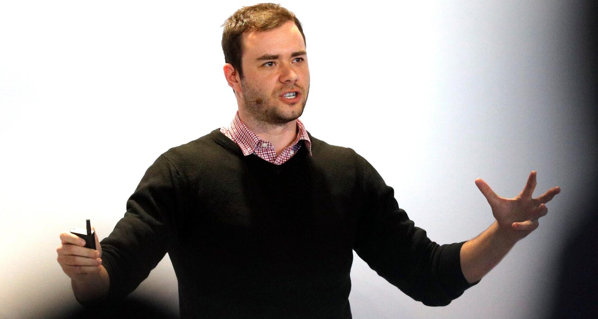 OpenAI CEO founding member Andrej Karpathy speaks to an audience with his arms open