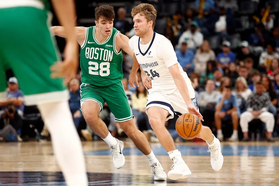 Oct 8, 2025; Memphis, Tennessee, USA; Memphis Grizzlies guard Cam Spencer (24) dribbles as Boston Celtics guard Hugo Gonzalez (28) defends during the third quarter at FedExForum. Mandatory Credit: Petre Thomas-Imagn Images