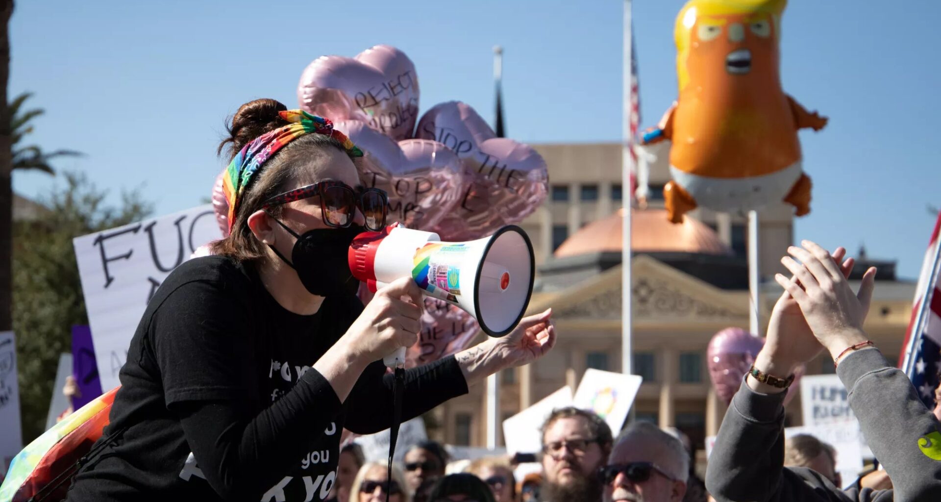 a protester yells into a megaphone