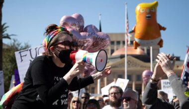 a protester yells into a megaphone