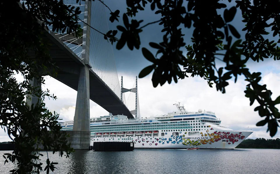 The Norwegian Cruise Line Ship Norwegian Gem heads West down the Saint Johns River as it passes under the Dames Point Bridge Wednesday May 27, 2020. The Norwegian Gem and the Norwegian Sky have been in Jacksonville since the cruise ship business was shut down by the COVID-19 pandemic and have been moored different places around Jacksonville's port facilities. [Bob Self/Times-Union]