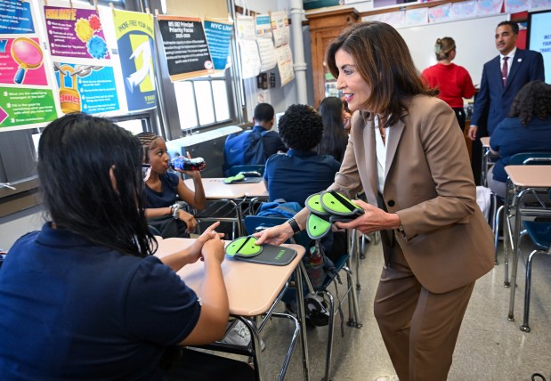 Gov. Kathy Hochul highlights distraction-free schooling by showing students new Yondr cell phone pouches at M.S. 582, The Magnet School for Multimedia Technology and Urban Planning, on Thursday, Sept. 4, 2025. (Susan Watts / Office of Governor Kathy Hochul)