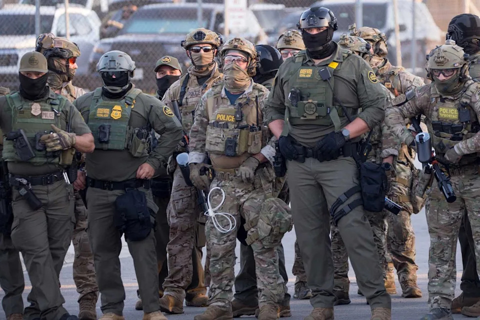 Jacek Boczarski/Anadolu via Getty ICE agents outside the ICE processing facility in Broadview, Ill. on Sept. 27