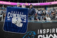 Dallas Cowboys fans hold a banners in the second half of an NFL football game against the...