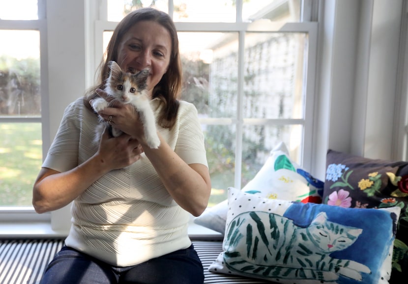 Susan Kennedy with her kitten Carrie at her home in Dallas on Oct. 11, 2025. Carrie the...