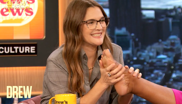 Drew Barrymore smells her co-hosts' feet during a recent broadcast of her daytime talk show.