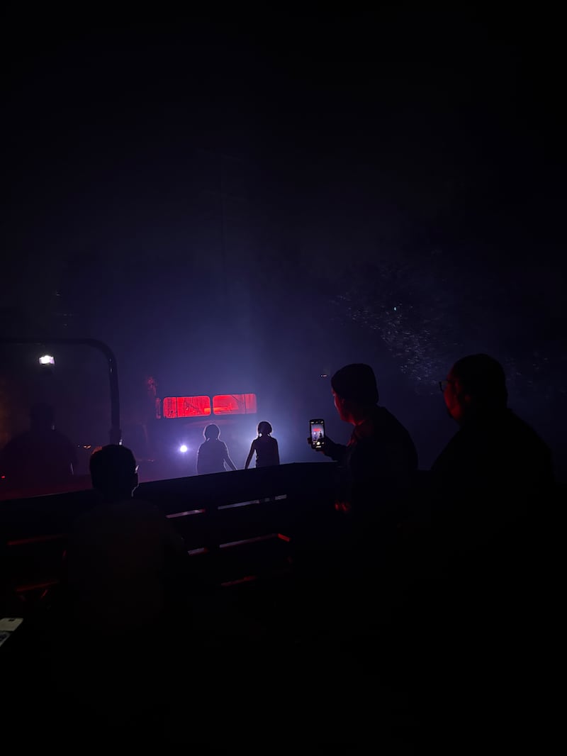 Photo of two scary twins holding hands at a stop on the hayride
