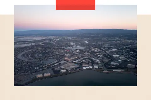 Smith Collection/Gado/Getty Images Aerial view of Silicon Valley at dusk, with a portion of the San Mateo/Hayward Bridge visible, as well as Foster City, including the California headquarters of Gilead Sciences, Visa, and Conversica, California