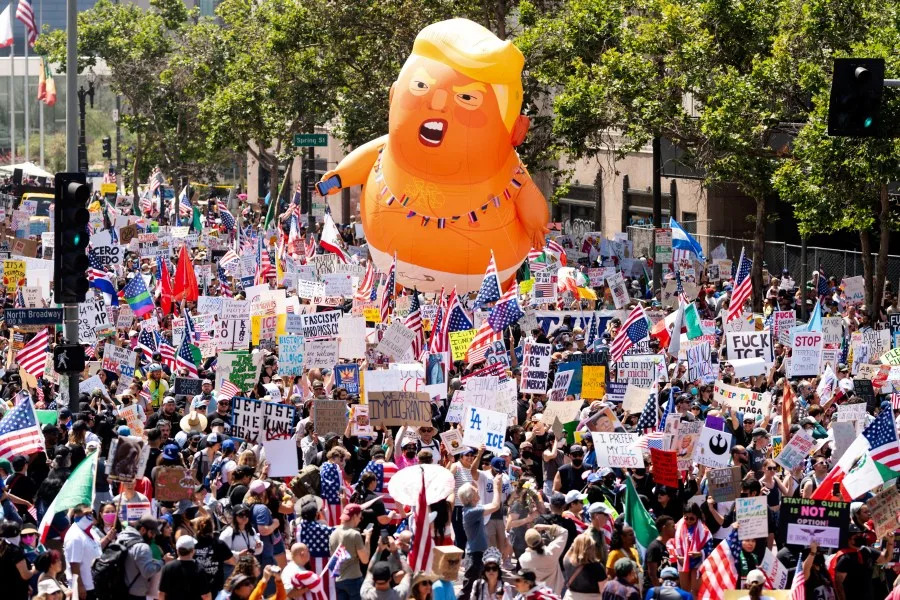 EDS NOTE: OBSCENITY – Demonstrators march in the “No Kings” protest with a President Donald Trump balloon in Los Angeles on Saturday, June 14, 2025. (AP Photo/Noah Berger)