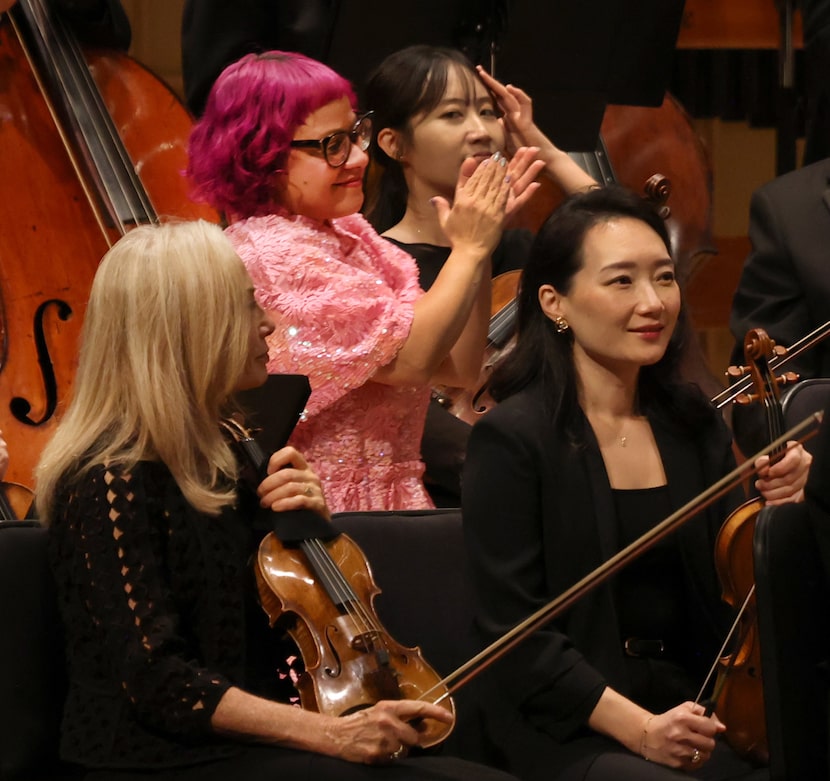 Angelica Negron emerges from the side stage applauding the musical talents represented...