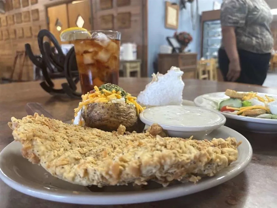 A chicken fried steak, baked potato, side salad and slice of lemon meringue pie from the Triple C Steakhouse in Devine, located 15 minutes from Bigfoot. (Mia Valdez/MySA)