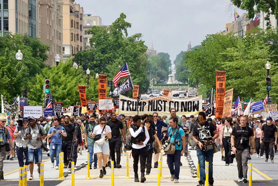Protesters rally at Lafayette Square during the “No Kings” protest in Washington, DC, on June 14, 2025, the day of President Trump’s military parade. In response to the military parade celebrating the 250th anniversary of the US Army but also coinciding with Trump’s 79th birthday, a “No Kings” movement has sprung up promising to stage protests in more than 2,000 places across the country, including a large parade expected in Los Angeles which organizers say will feature a “20-foot-tall balloon of Trump wearing a diaper.” (Photo by Amid FARAHI / AFP) (Photo by AMID FARAHI/AFP via Getty Images)