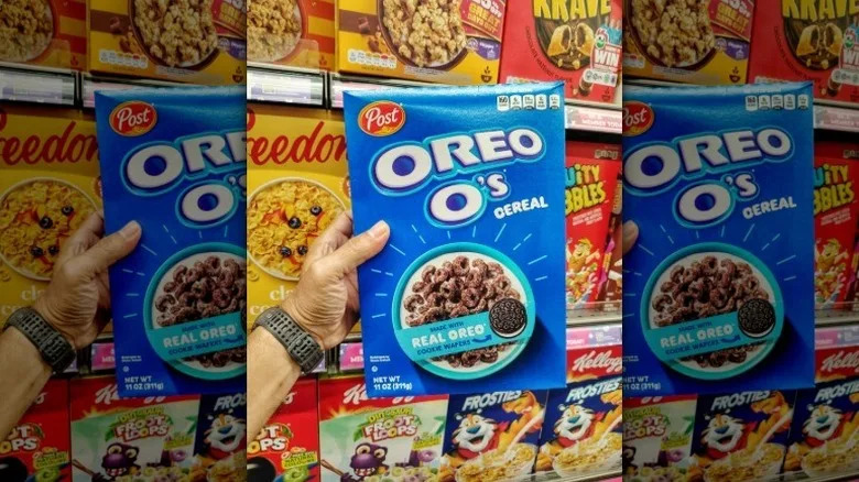 Hand holding a box or Oreo O's at the grocery store