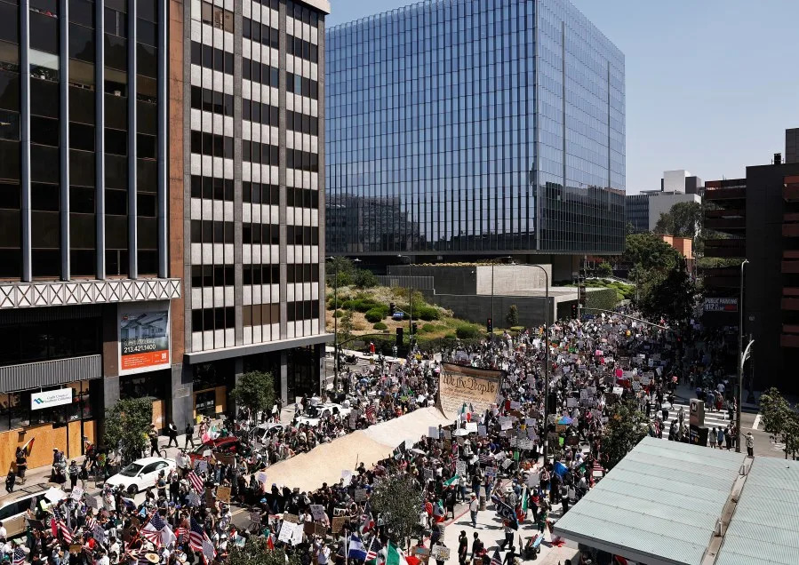 LOS ANGELES, CALIFORNIA – JUNE 14: Protesters carry a banner representing the Preamble to the U.S. Constitution in downtown Los Angeles during an anti-Trump “No Kings Day” demonstration in a city that has been the focus of protests against Trump’s immigration raids on June 14, 2025 in Los Angeles, California. Hundreds of marches and protests against the Trump administration and its policies are happening across the United States today. Protesters are also reacting in opposition to a planned military parade celebrating the 250th anniversary of the U.S. Army that is taking place in Washington, DC and which coincides with President Trump’s birthday. (Photo by Mario Tama/Getty Images)