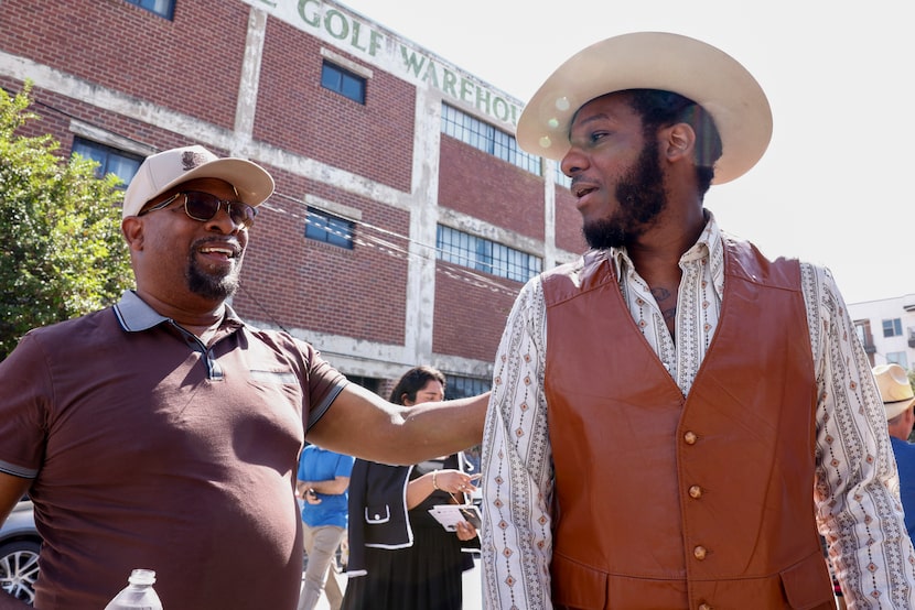 Musician Leon Bridges talks with his father, Wallace Bridges, before a ceremony dedicating a...