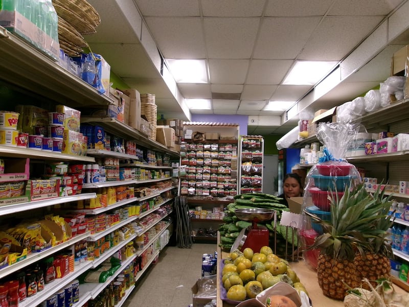 Photo of the inside of a market which has many fresh fruits.