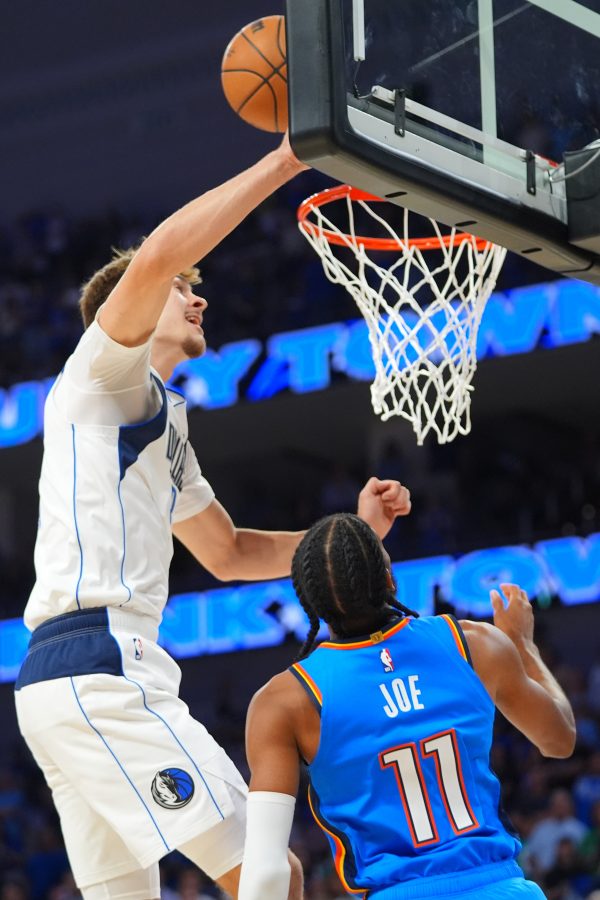 A basketball player gets a block.