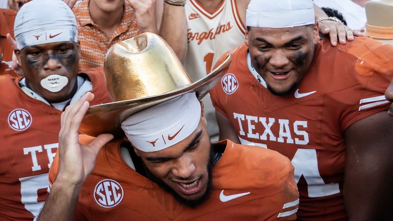 Texas wide receiver DeAndre Moore Jr. (0) celebrates beating Oklahoma in an NCAA college football game at the Cotton Bowl in Dallas, Saturday, Oct. 11, 2025. (Sara Diggins/Austin American-Statesman via AP)
