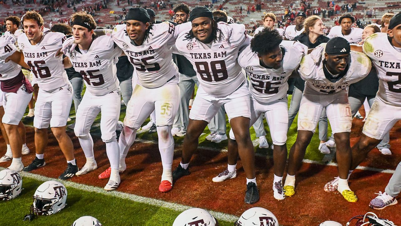 Texas A&M players celebrate in front of their fans after defeating Arkansas during an NCAA college football game Saturday, Oct. 18, 2025, in Fayetteville, Ark. (AP Photo/Michael Woods)