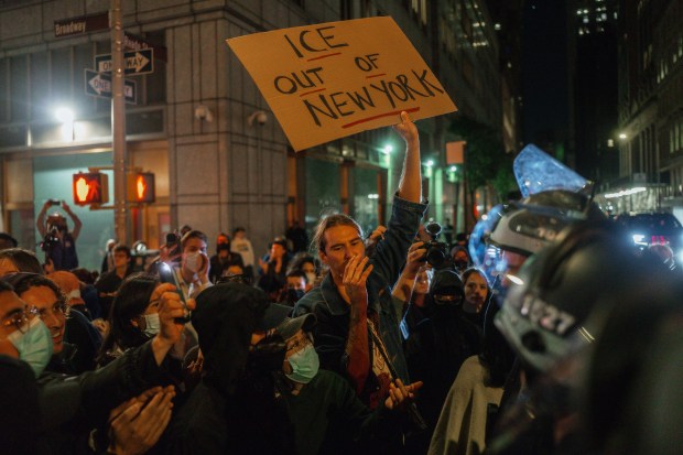 Protesters shout slogans during a protest against immigration crackdown in the aftermath of a raid on Tuesday, Oct. 21, 2025, in New York. (AP Photo/Olga Fedorova)