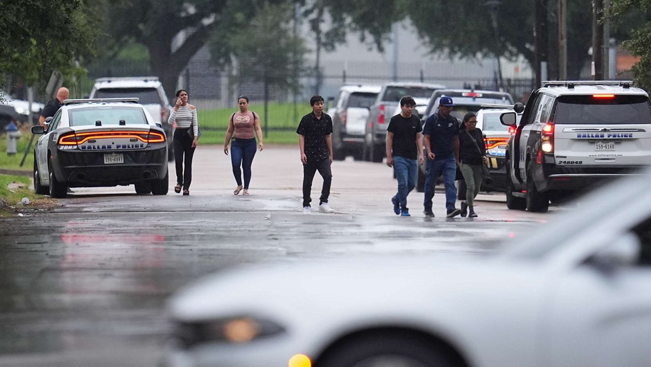 People who had appointments at a U.S. Immigration and Customs Enforcement office are turned away after a reported shooting in the facility in Dallas on Wednesday, Sept. 24, 2025. (AP Photo/Julio Cortez)