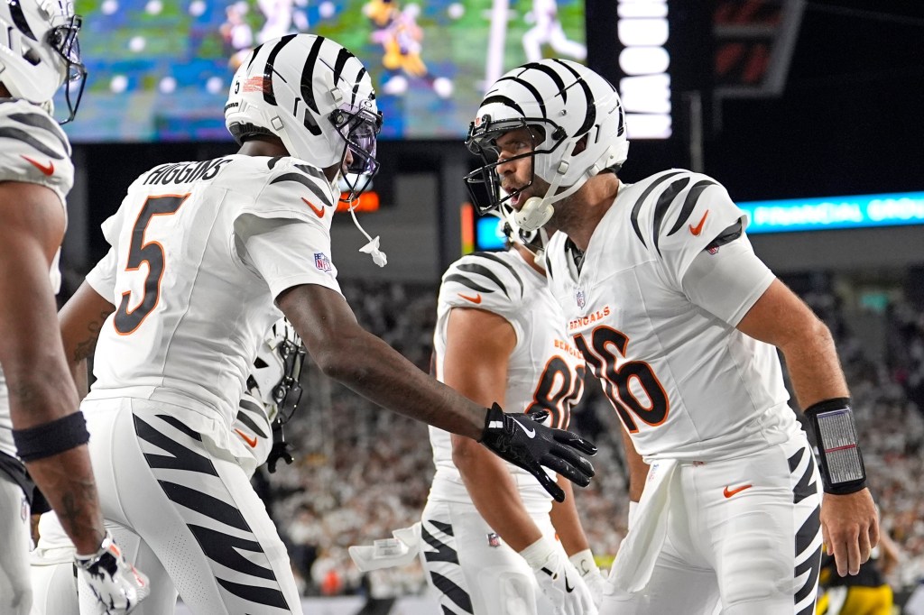 Cincinnati Bengals quarterback Joe Flacco (16) celebrates after a touchdown with wide receiver Tee Higgins (5) during the first half of an NFL football game against the Pittsburgh Steelers in Cincinnati, Thursday, Oct. 16, 2025.
