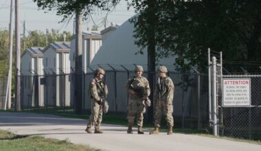 Military personnel in uniform, with the Texas National Guard patch on, are seen at the U.S. Army Reserve Center, Wednesday, Oct. 8, 2025, in Elwood, Ill., a suburb of Chicago. (AP Photo/Laura Bargfeld)
