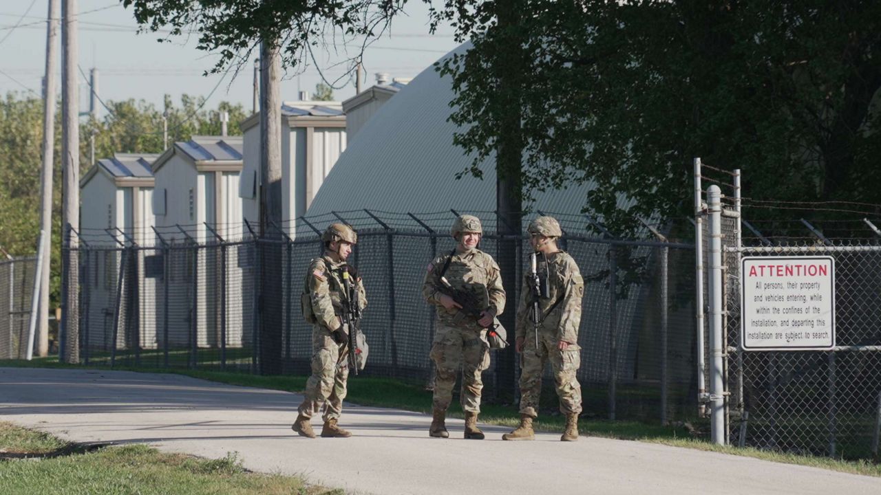 Military personnel in uniform, with the Texas National Guard patch on, are seen at the U.S. Army Reserve Center, Wednesday, Oct. 8, 2025, in Elwood, Ill., a suburb of Chicago. (AP Photo/Laura Bargfeld)
