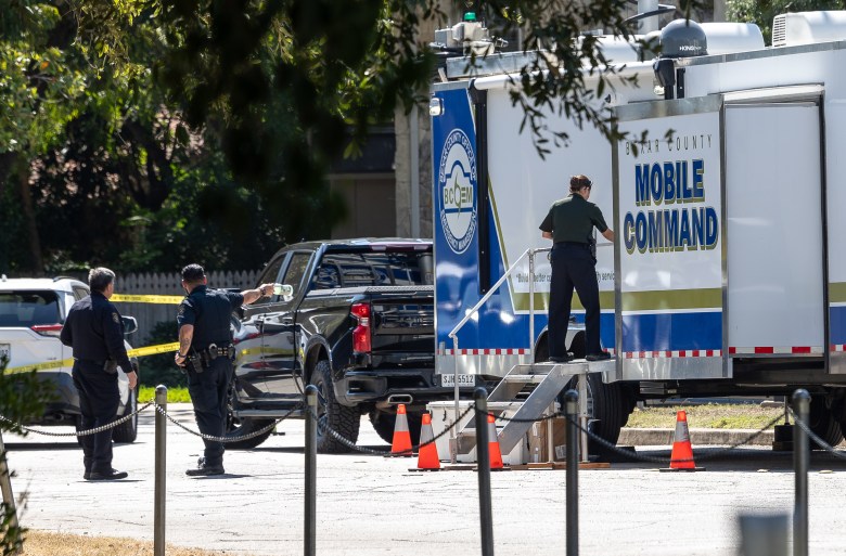Police and investigators are seen on E Countour Drive in Olmos Park near the home of Suzanne Simpson, who has been missing since Sunday, Oct. 6. As of Wednesday morning, her husband, Brad Simpson, has been arrested.