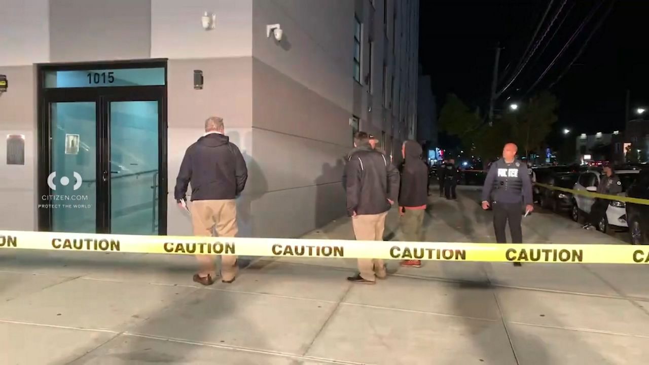 During a struggle on Gun Hill Road, one officer fell and hit his head, while another opened fire, striking the suspect twice. (Citizen APP via Spectrum News NY1)